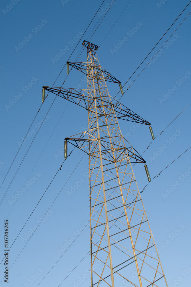 Electric power station lines, on the blue sky backing in the sunset Electric power station lines, on the blue sky backing in the sunset