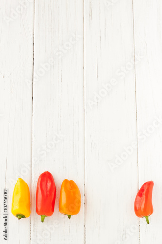 Colorful mini paprika on a white wooden table