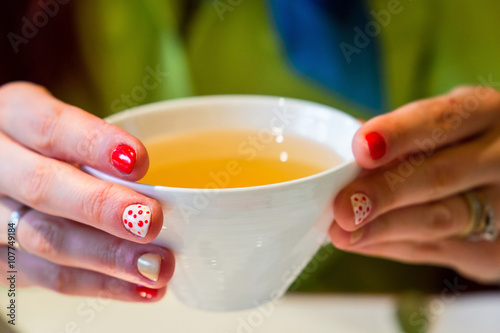 Woman Hands Holding Cup of Green Tea, Close-up
