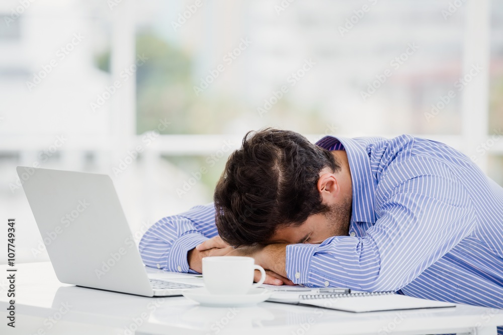 Businessman putting his head down on desk Businessman putting his head down on desk