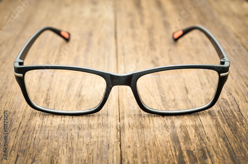 Black eye glasses on wooden floor, Close up image