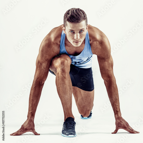 Full length portrait of a fitness man running isolated on a white background