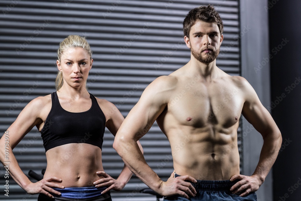Fit couple with hands on the hips Fit couple with hands on the hips