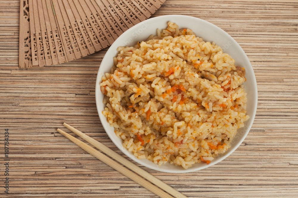 bowl of cooked rice with chopsticks and fan bowl of cooked rice with chopsticks and fan