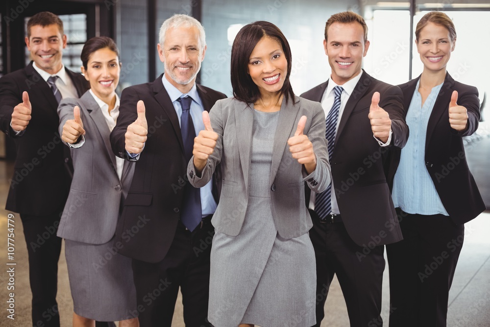 Businesspeople standing together and giving thumbs up Businesspeople standing together and giving thumbs up