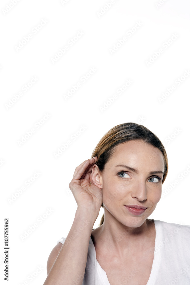 Young Caucasian woman with hand on ear hearing Young Caucasian woman with hand on ear hearing