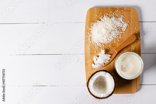 Whole and broken coconut with grated cocont flakes and coconut oil or butter. photo