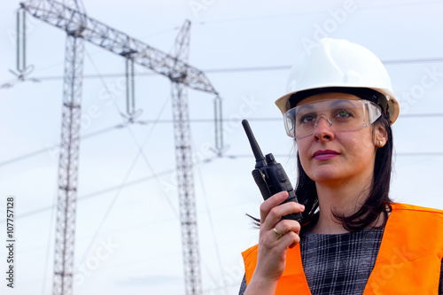 Electrical distribution engineer talking  on a walkie- talkie photo