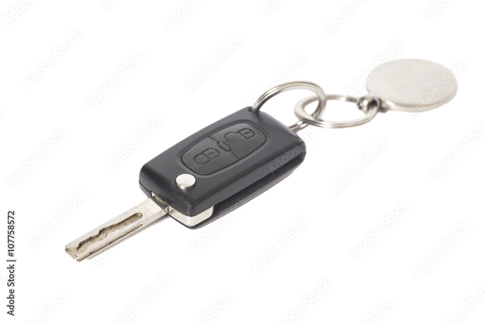 Remote control car key with metal keyring on isolated white back Remote control car key with metal keyring on isolated white back