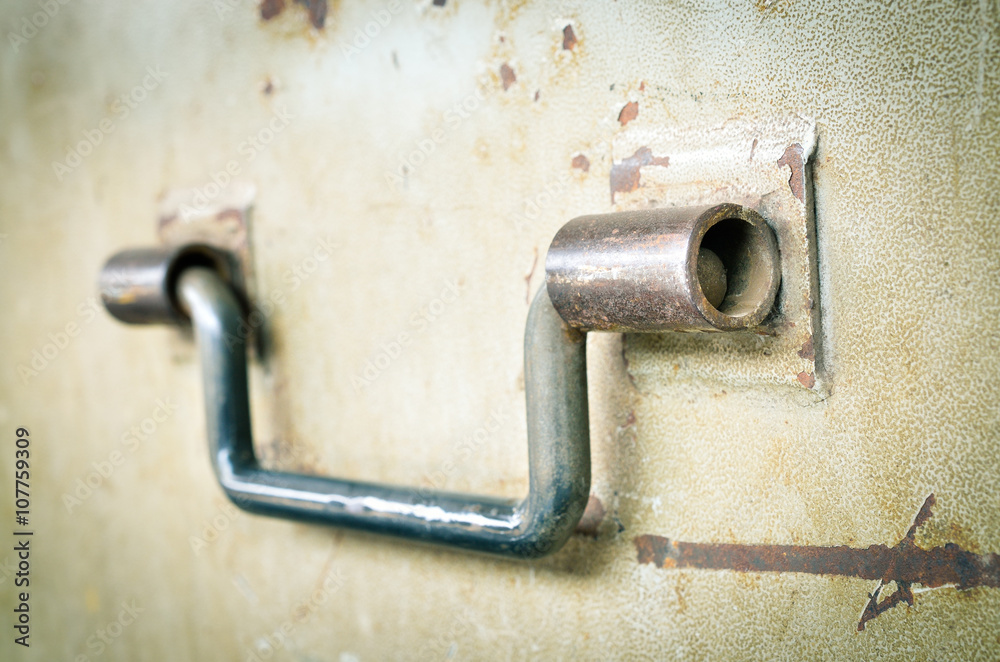 Selective focus and close up / Steel handle on old steel door