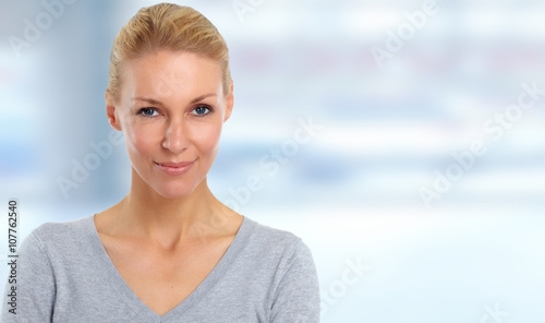 Beautiful woman face over blue abstract background.