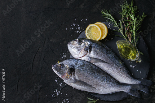 Raw bream fish with herbs photo
