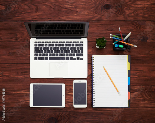 Gadgets and notebook on the table photo