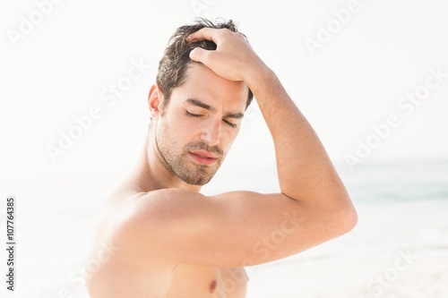Fit man posing on the beach