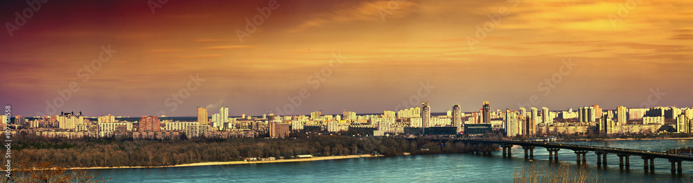 Tinted evening cityscape of Kiev. Panorama of the left bank of the Dnieper.