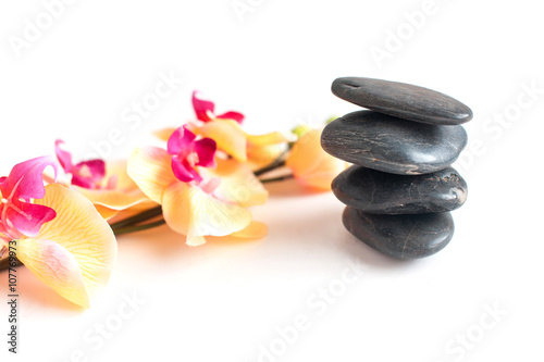 four dark gray stone and bright Orchid branch