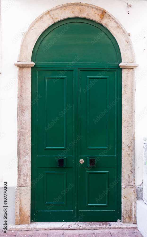 Green door. entrance door in front of residential house.