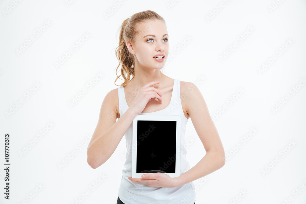 Pensive woman showing blank tablet computer screen Pensive woman showing blank tablet computer screen
