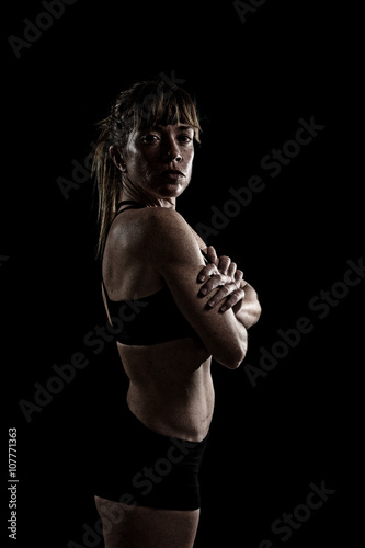 strong sport freckles woman posing defiant in cool attitude with welt built body