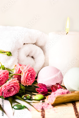 Spa setting with pink roses and aroma oil, vintage style 