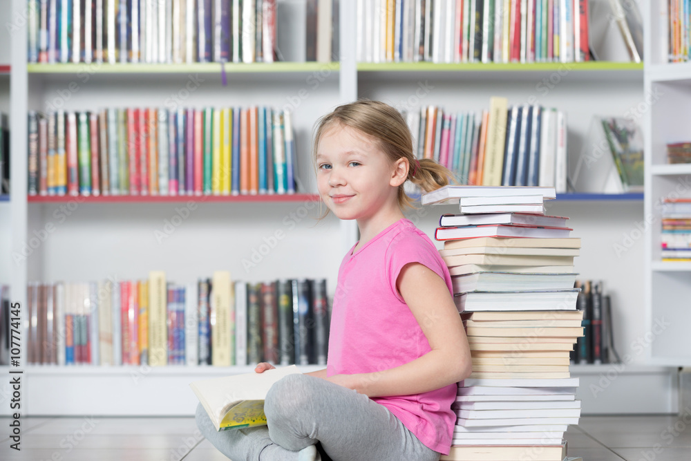 Cute girl reading book in library
Cute girl reading book in library