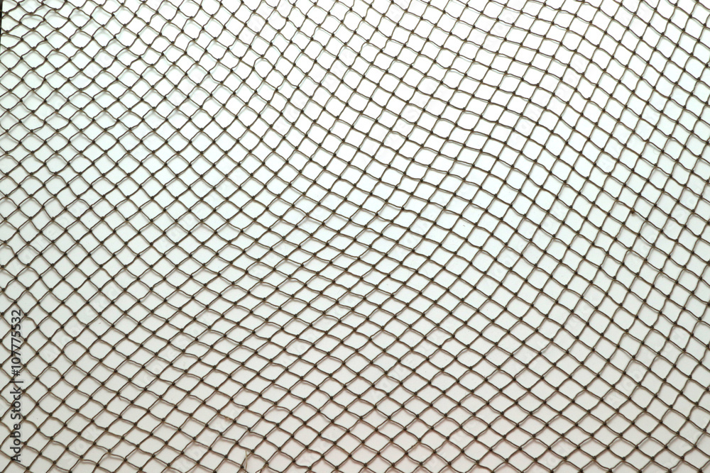 Close up of fish net against white background - obrazy, fototapety, plakaty 