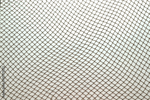 Close up of fish net against white background