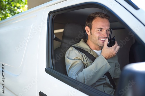 Delivery driver talking on walkie-talkie photo