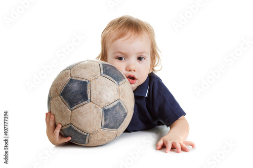 Baby boy playing with a soccer ball. Isolated on white