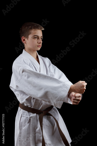 Karate Fighter in white Kimono Isolated on Black