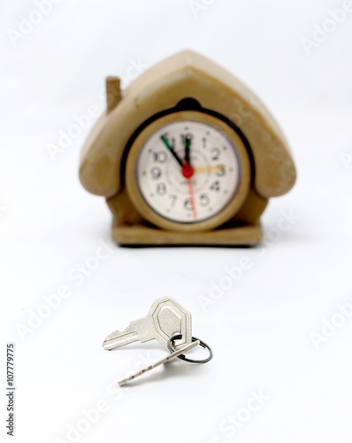 keys in front of vintage house shape alarm clock