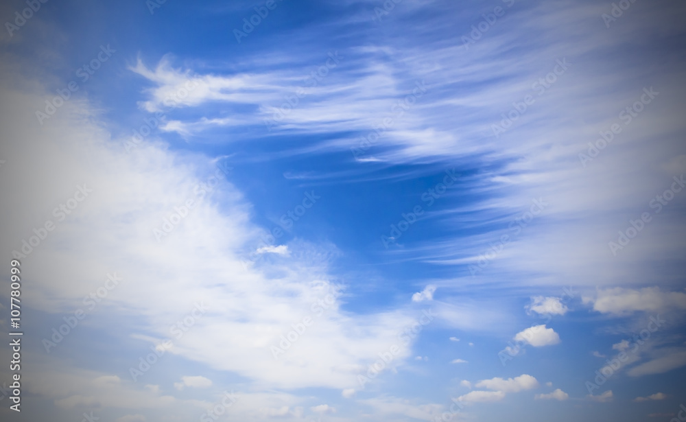 White cirrus clouds and a bright blue sky. Bright, high-contrast picture, nature.
