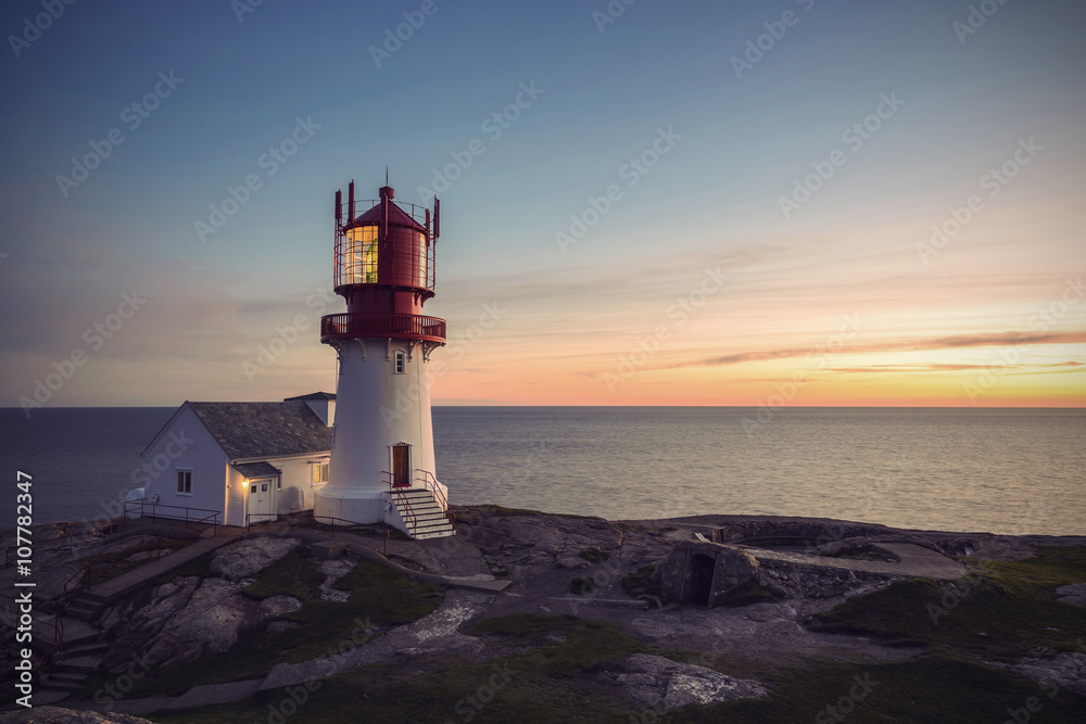 Lighthouse Lindesnes Fyr at sunset on most southern point of Norway, Europe, Vintage filtered style
