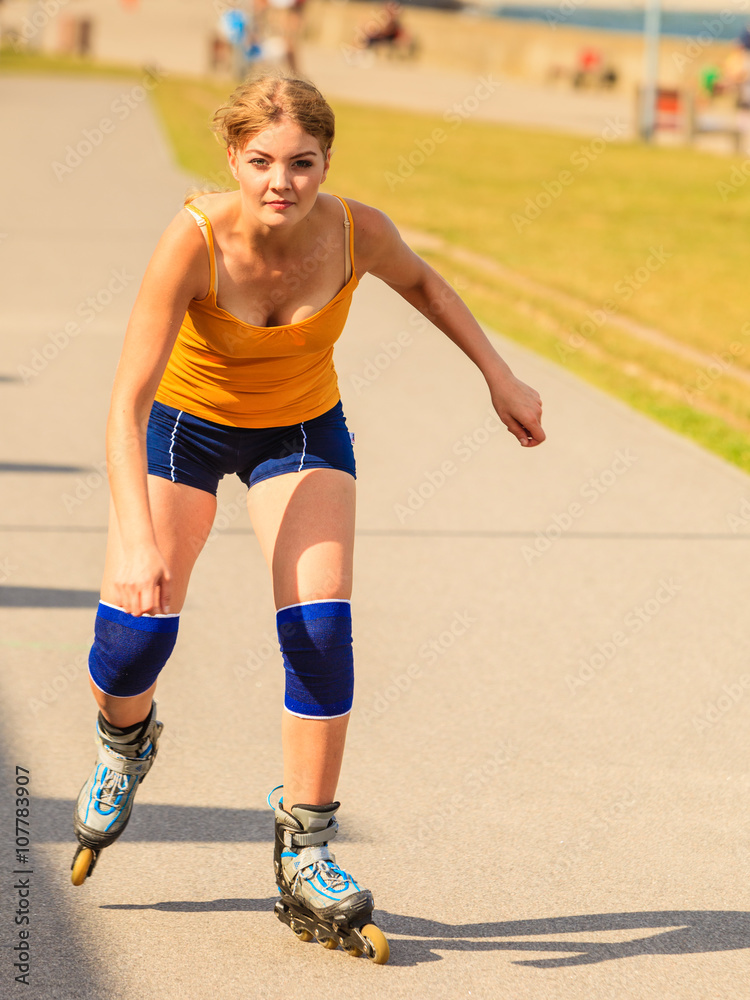 Young woman rollerblading outdoor on sunny day