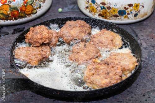 Minced meat burgers frying in the hot oil