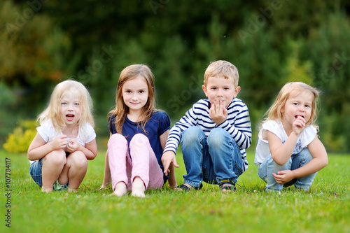 Four adorable little kids outdoors © MNStudio