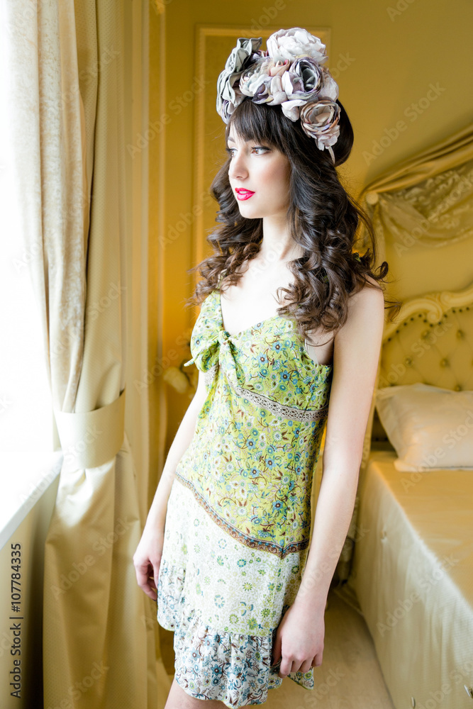 Fototapeta premium beautiful young woman wearing floral wreath on had