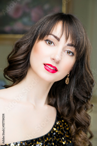 Beautiful face of young woman with clean skin and red lips