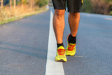 Runner man feet running on road closeup on shoe. Male fitness mo