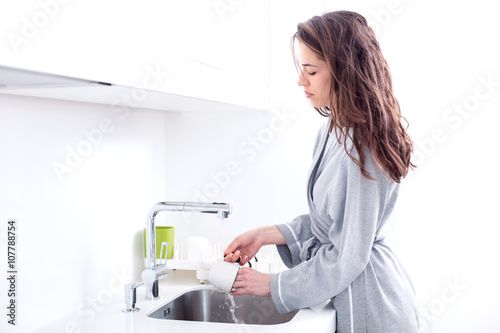Woman preparing morning coffee in the kitchen
