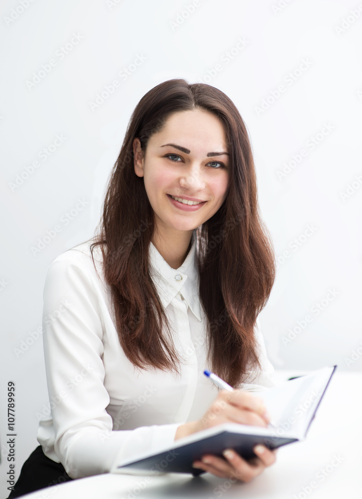 smiling business woman writes notes in diary smiling business woman writes notes in diary