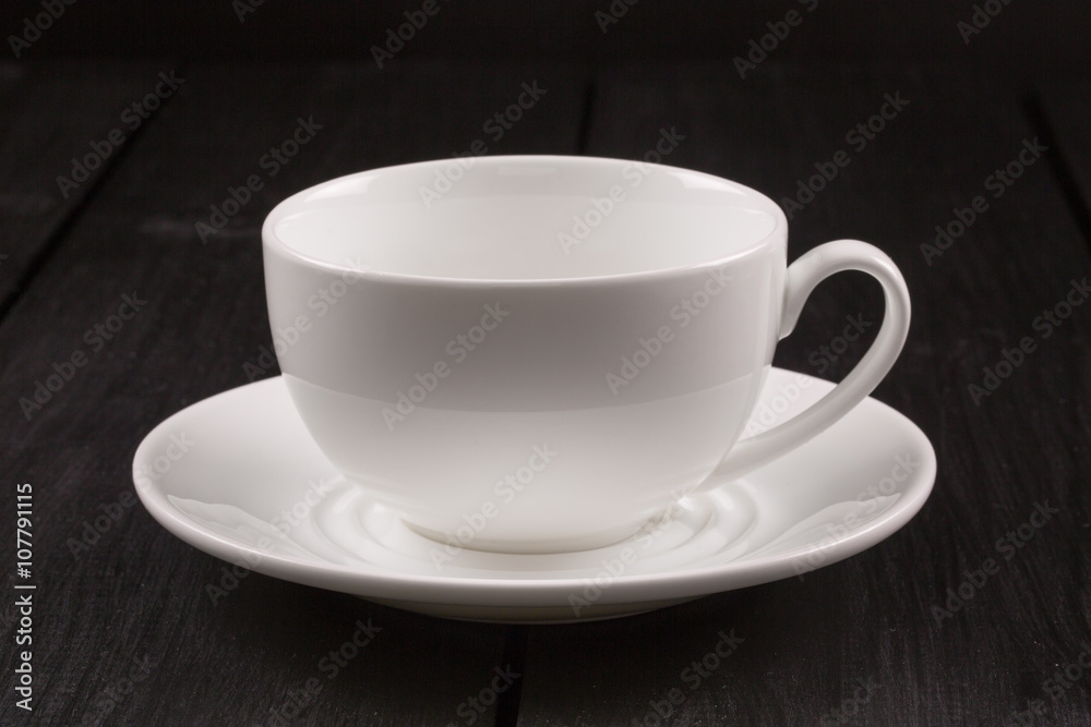 Cappuccino with cinnamon in a white cup. Coffee on Black Wooden Table Cappuccino with cinnamon in a white cup. Coffee on Black Wooden Table