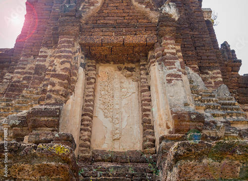 Archaeological site at Phitsanulok in Thailand with sun flare photo