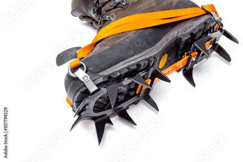 leather climbing boots with crampons, isolated on white backgrou