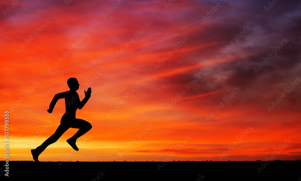 Silhouette of running man against the colorful sky. 