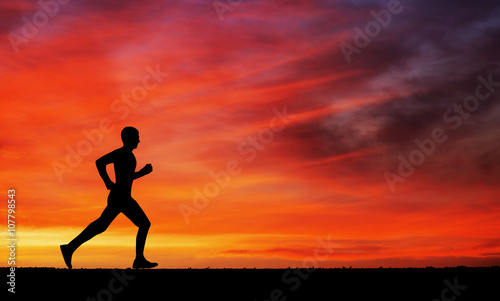 Fototapeta Naklejka Na Ścianę i Meble -  Silhouette of running man against the colorful sky. 