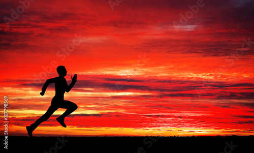 Silhouette of running man against the colorful sky. Silhouette o