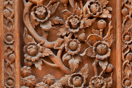 Flowers carved on a wooden board of ancient door