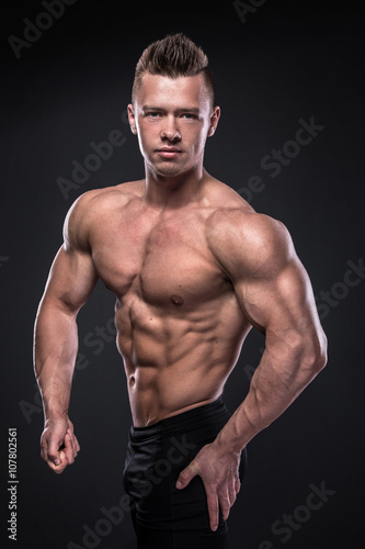 Young bodybuilder showing his muscles