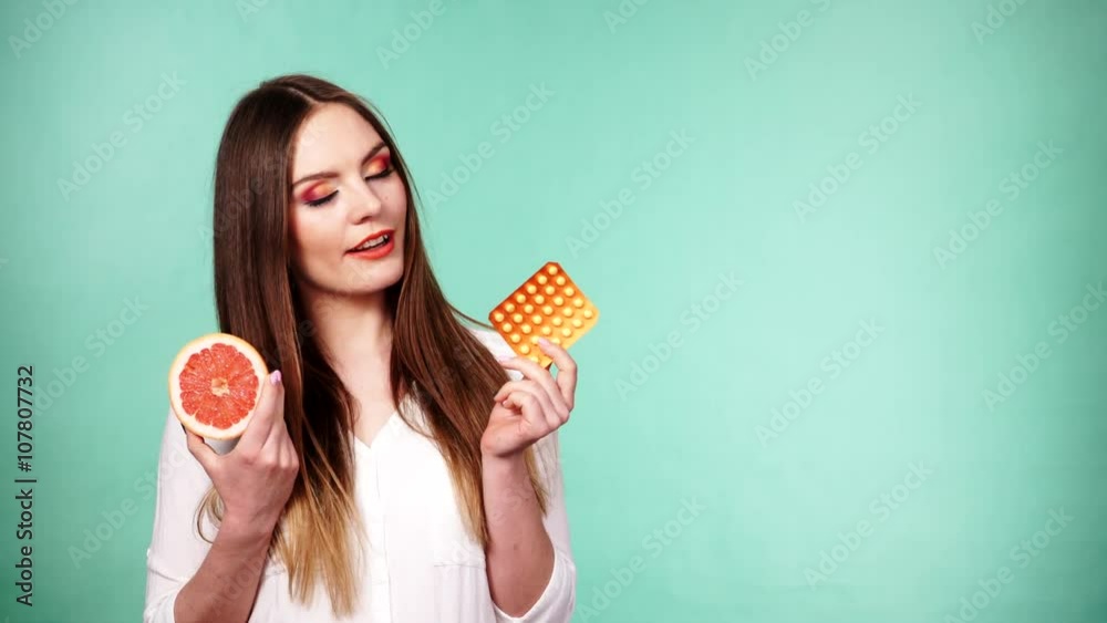 Woman holding pills blister pack vitamin c and grapefruit 4K